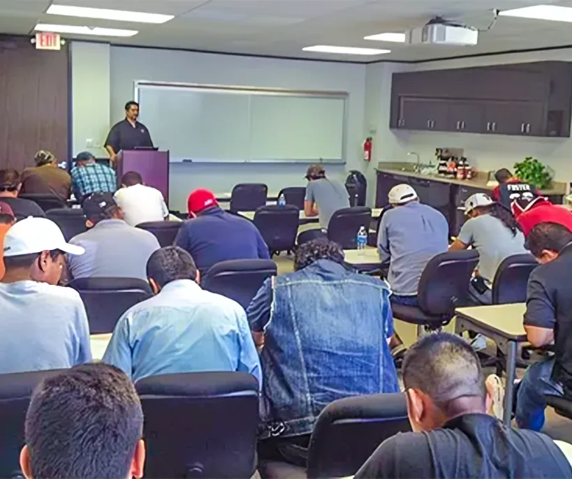 Crew seated in a training room during a Chris Harp Construction safety meeting